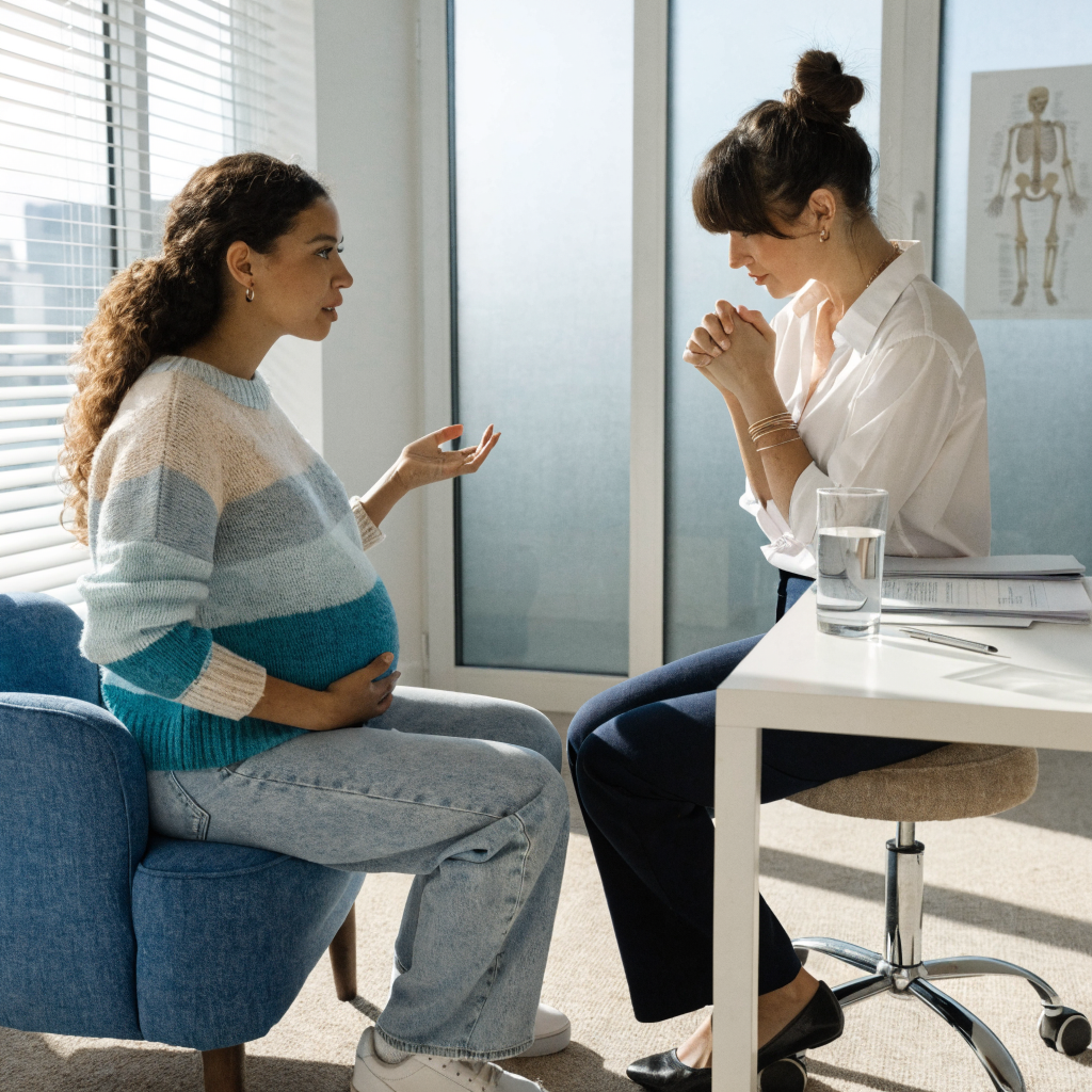 Pregnant woman discussing mental health concerns with a healthcare professional
